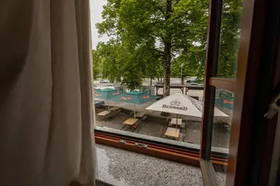 a view from a window of a patio with tables and umbrellas at Pr'Finzgar in Brezje