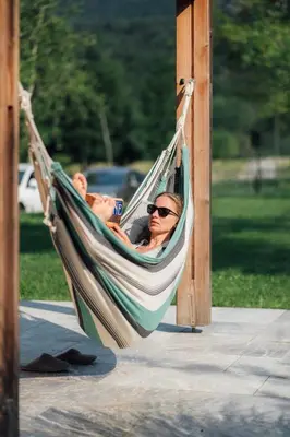 two people laying in a hammock at Holiday House BALE, BALE in Kostel