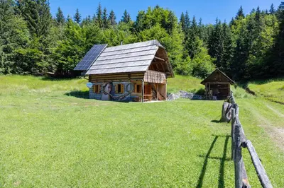 a log cabin in the middle of a field at Apartment in Chalet Goldilocks in Zgornje Gorje