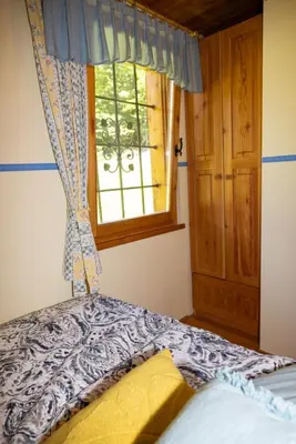a bedroom with a bed and a window at Apartment in Chalet Goldilocks in Zgornje Gorje
