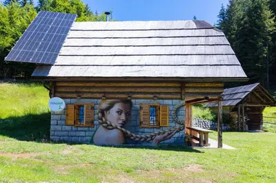 a building with a woman painted on the side of it at Apartment in Chalet Goldilocks in Zgornje Gorje