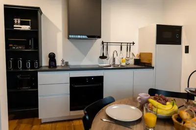 a kitchen with a table with a bowl of bananas on it at Kavenija apartmaji - Free Parking in Maribor