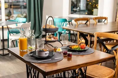 a table with two plates of food on it at Kavenija apartmaji - Free Parking in Maribor