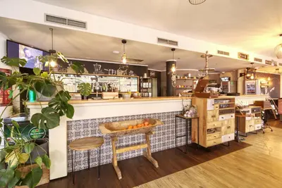 a restaurant with a counter and a table with oranges on it at Kavenija apartmaji - Free Parking in Maribor