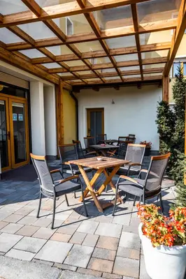 a wooden table and chairs on a patio at B&B Bau in Maribor