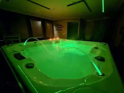 a green bath tub with lights in a bathroom at zidanica Bunderšek in Šentjanž