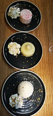 three plates of donuts on a wooden table at Guesthouse Pr'Šefu in Brežice