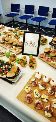 a table filled with different types of sandwiches and pastries at Guesthouse Pr'Šefu in Brežice