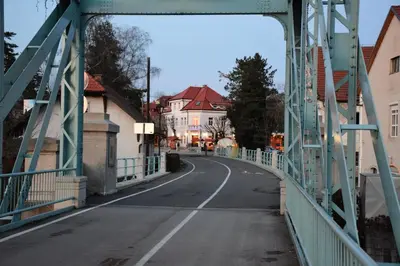 a bridge over a road with houses on it at Guesthouse Pr'Šefu in Brežice