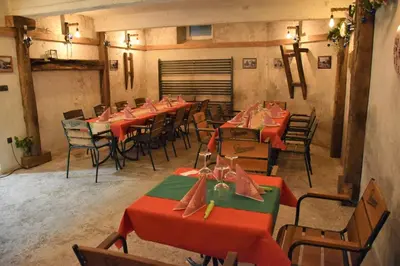 a dining room with red tables and chairs at Guesthouse Pr'Šefu in Brežice