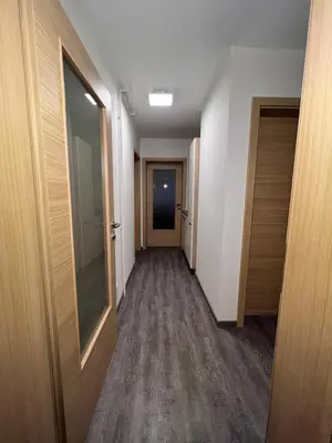 a hallway of an office building with a door and a hallwayngth at Mici's Apartments in Visoko