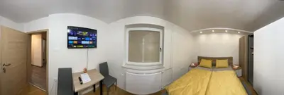 a small room with a bed and a window at Mici's Apartments in Visoko