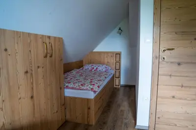 a bedroom with a bed in a wooden cabinet at A house with the view in Srednja Vas v Bohinju