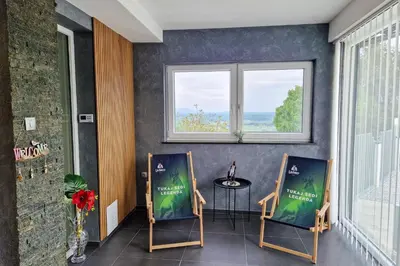 a room with two chairs and a table and a window at Apartma Lara in Lesično