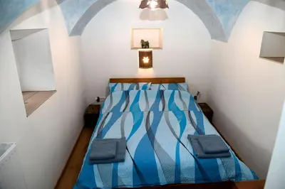 a small bedroom with a blue bed in a room at Pri Matičku in Bohinj