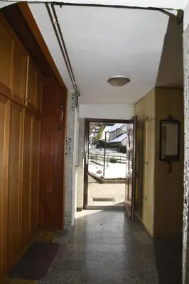 an empty hallway of a house with a door open at Pri Matičku in Bohinj