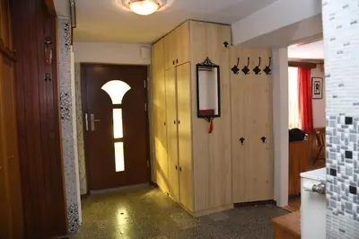 a hallway with a door with a light shining through at Pri Matičku in Bohinj