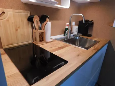 a kitchen counter with a sink and a knife holder at Vali's Paradise in Ptuj