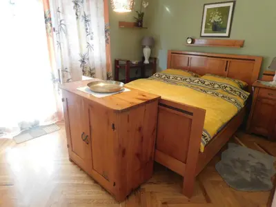 a bedroom with a wooden bed with a bowl on it at Vali's Paradise in Ptuj