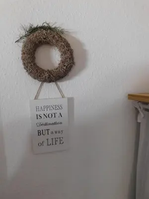 a sign hanging on a wall with a nest at Vali's Paradise in Ptuj