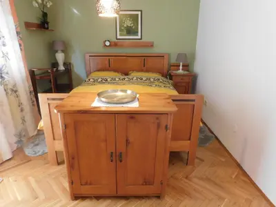 a bedroom with a bed with a bowl on a wooden table at Vali's Paradise in Ptuj