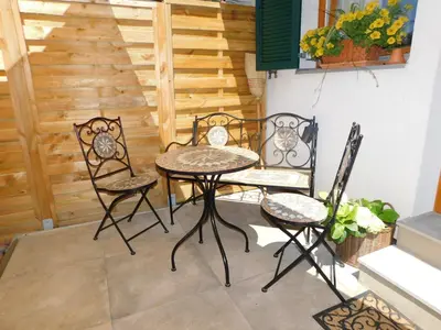 a table and chairs on a patio with a staircase at Vali's Paradise in Ptuj