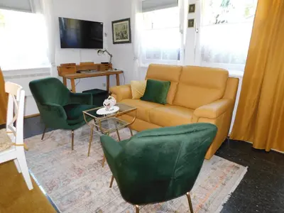 a living room with a couch and two chairs at Vali's Paradise in Ptuj