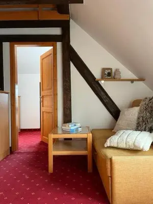 a living room with a couch and a table at Chalet Burja at Vogel mountain - cable car access or hiking - not reachable with car in Bohinj
