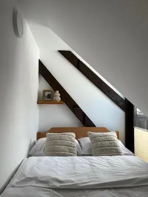a bedroom with a bed with pillows on it at Chalet Burja at Vogel mountain - cable car access or hiking - not reachable with car in Bohinj