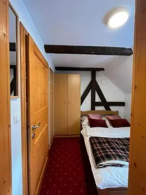 a small room with two beds in a room with a ceiling at Chalet Burja at Vogel mountain - cable car access or hiking - not reachable with car in Bohinj