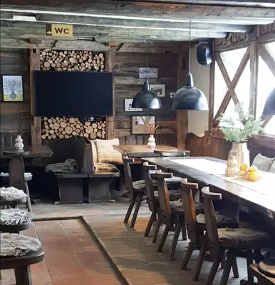 a dining room with a large wooden table and chairs at Chalet Burja at Vogel mountain - cable car access or hiking - not reachable with car in Bohinj