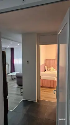 a bedroom with a bed in the middle of a room at Apartmani MURIC Ljubljana in Ljubljana