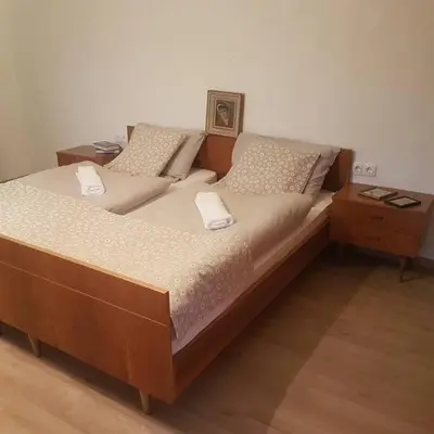 a large bed with two pillows on top of it at Miklavževa hiša with a bread oven in Železniki