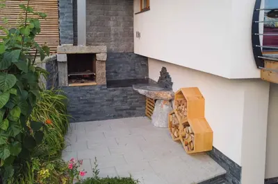 a patio with a stone oven next to a building at Holiday home in Sentvid pri Sticni - Zentralslowenien 43927 in Šentvid pri Stični
