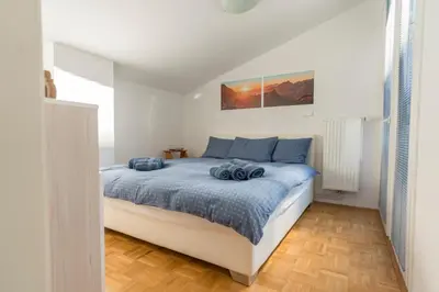 a bedroom with a bed with blue pillows on it at DREAM & RELAX Apartment in Bohinj