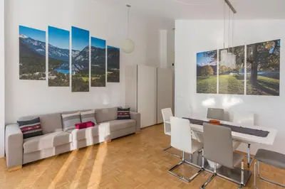 a living room with a couch and a dining table at DREAM & RELAX Apartment in Bohinj