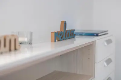 a white counter top with a wooden sign on it at DREAM & RELAX Apartment in Bohinj