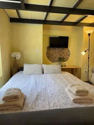 a bedroom with a large bed with towels on it at Central Oasis-with parking in Ljubljana
