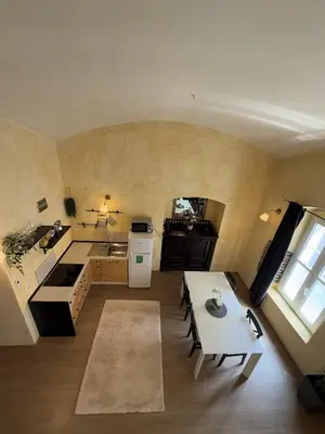 a kitchen with a table and a white refrigerator at Central Oasis-with parking in Ljubljana