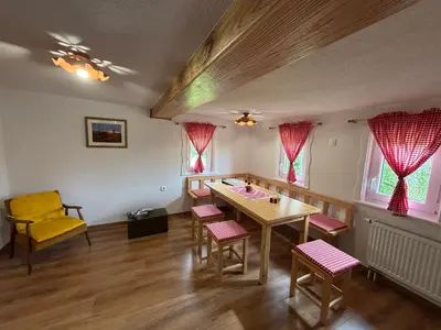 a dining room with a table and chairs at Grunt Sonek in Mislinja