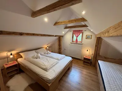a bedroom with a bed with two teddy bears on it at Grunt Sonek in Mislinja