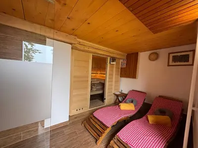 a small porch with two chairs and a window at Grunt Sonek in Mislinja