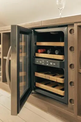 a kitchen with an open oven with wine bottles at Apartment Mountain Sunrise in Škofja Loka