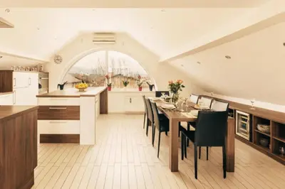 a kitchen and dining room with a table and chairs at Apartment Mountain Sunrise in Škofja Loka