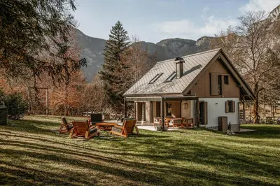 a house with a table and chairs in the yard at Fox on the Rocks Chalet in Bohinj