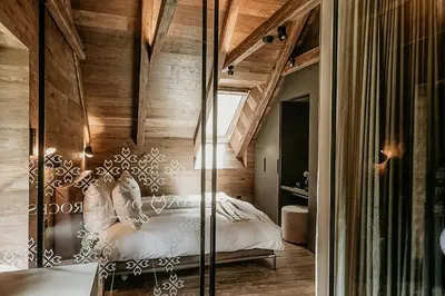 a bedroom with a bed and a wooden ceiling at Fox on the Rocks Chalet in Bohinj