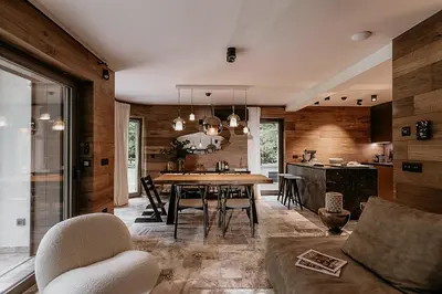 a dining room and kitchen with a table and chairs at Fox on the Rocks Chalet in Bohinj