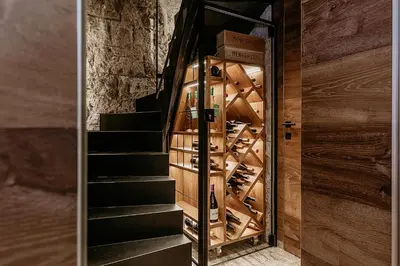 a room with a wine cellar with wooden stairs at Fox on the Rocks Chalet in Bohinj