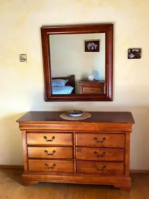 a wooden dresser with a mirror on top of it at ADORI in Ilirska Bistrica