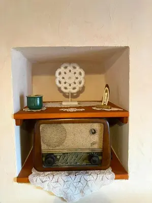 a small wooden box with a radio on a shelf at ADORI in Ilirska Bistrica